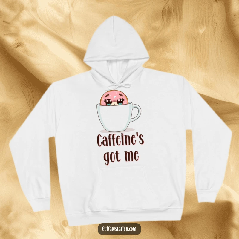 Funny donut hoodie shows a startled donut hiding behind a huge coffee cup, offering a blend of comfort and humor.