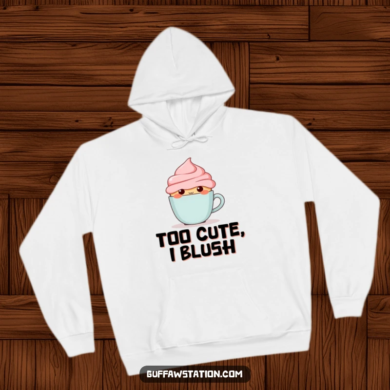 Funny blushing cupcake hiding behind a tiny coffee cup, depicted on a warm and cozy hoodie.