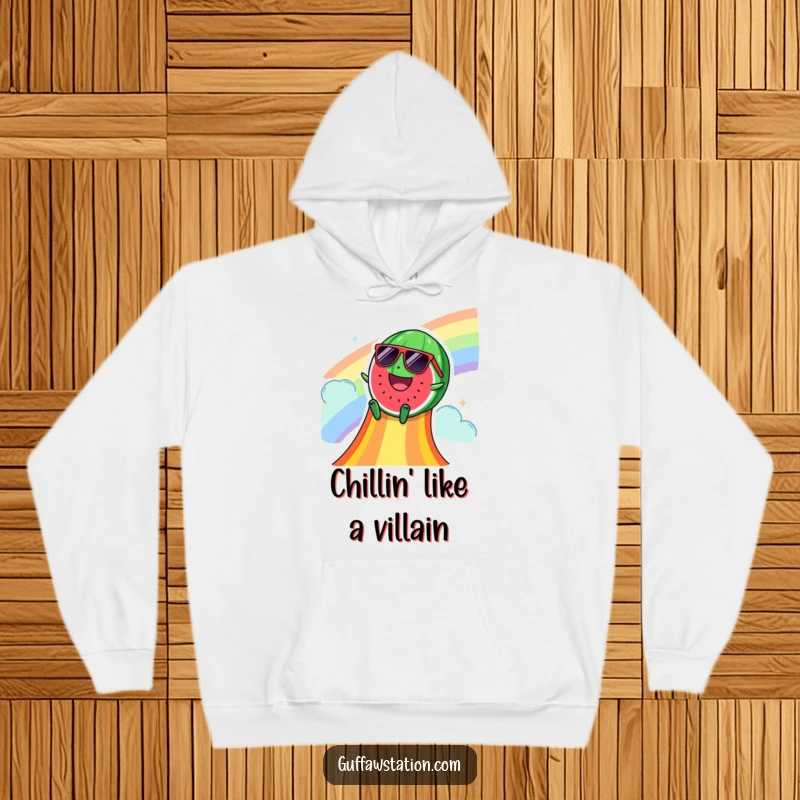 Funny hoodie with a happy watermelon sporting sunglasses, sliding down a rainbow slide, offering cozy vibes and summer cheer.