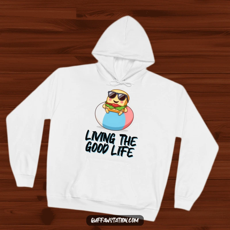 Funny hoodie design of a smiling sandwich with sunglasses, relaxing on a giant beach ball, cartoon style.