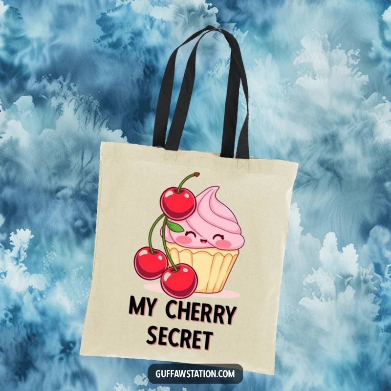 Funny tote bag with a shy cupcake character hiding behind a large cherry, ideal for carrying essentials with sweet, humorous charm.